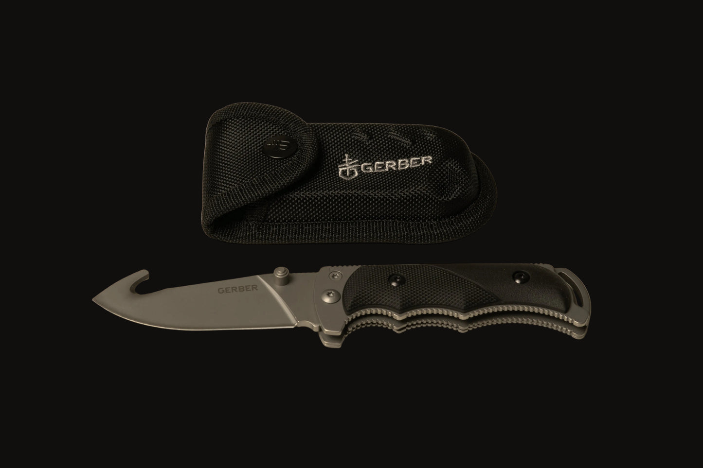 Folding knife with a black sheath on a beige background, featuring the Gerber brand.
